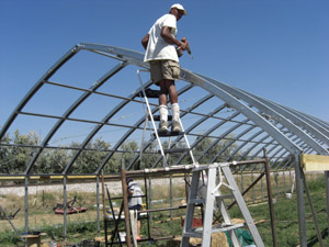 Owner assembling High Tunnel house during July through October 2011